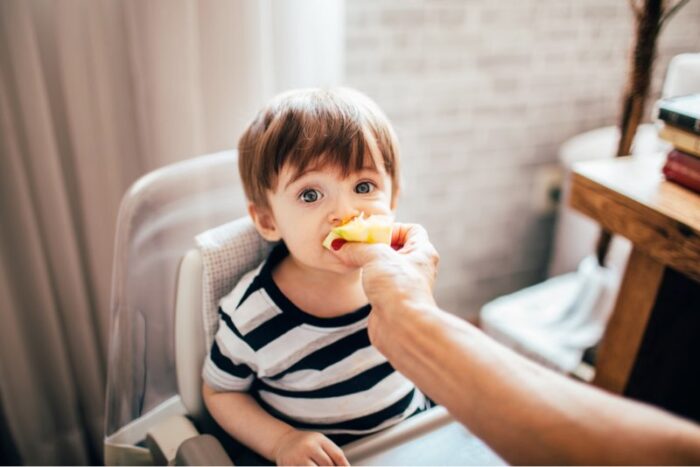 child eating fruit